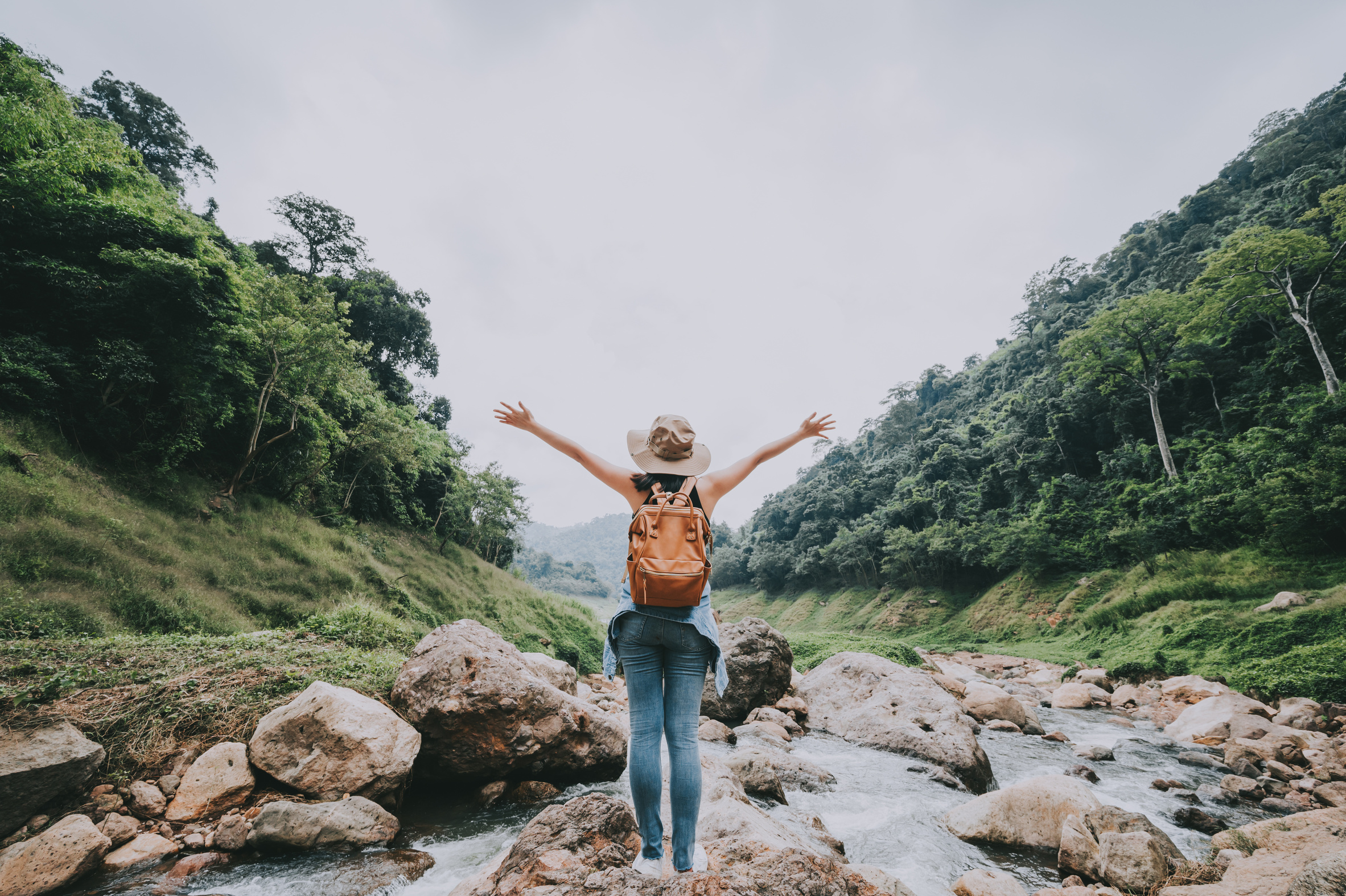 Woman with Arm Raised Feeling Free Enjoying Nature